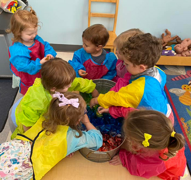 Daniel Island Academy children gathered around an activity